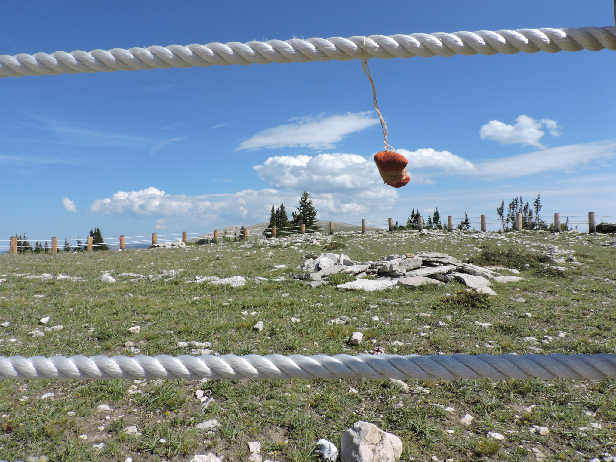 A prayer bundle left by a pilgrim dances in the Wyoming wind